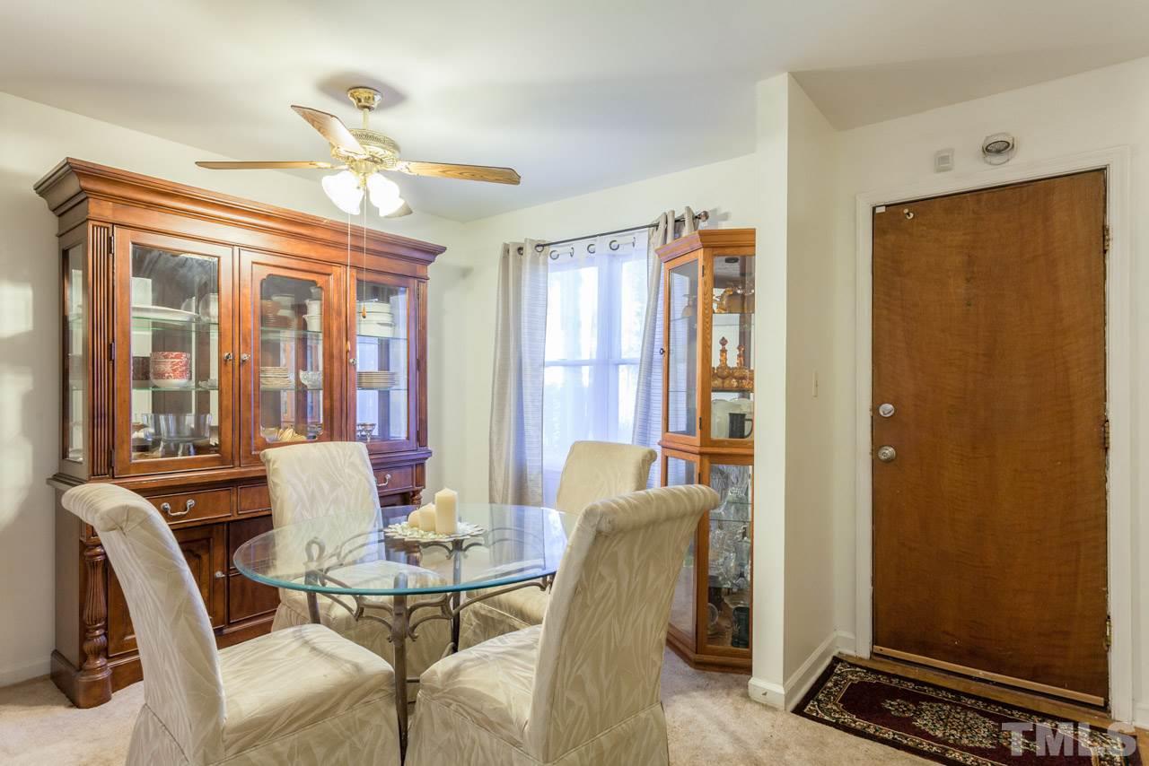 6904 Falls Of Neuse Road, Unit 6904 Raleigh, NC 27615 - Photo 8 of 23 a view of a dining room with furniture window and outside view