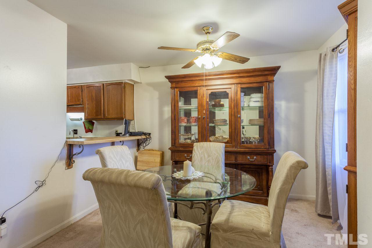 6904 Falls Of Neuse Road, Unit 6904 Raleigh, NC 27615 - Photo 9 of 23 a view of a dining room with furniture