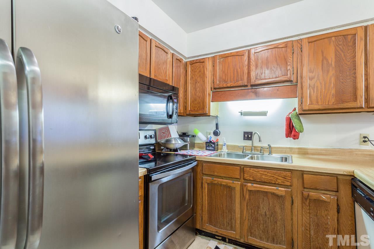 6904 Falls Of Neuse Road, Unit 6904 Raleigh, NC 27615 - Photo 10 of 23 a kitchen with a sink appliances and cabinets
