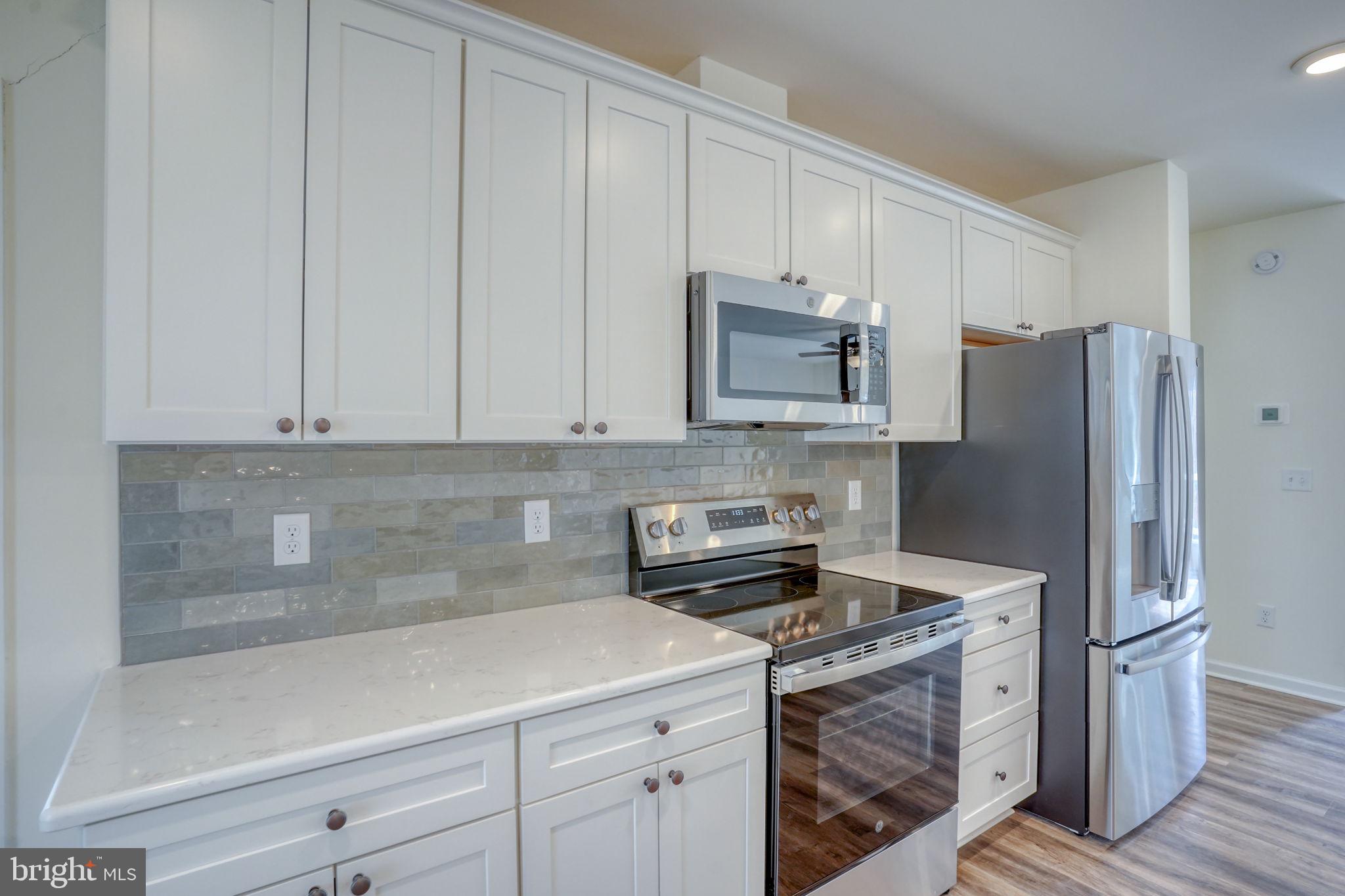 156 Pratts Branch Road Felton, DE 19943 - Photo 12 of 35 a kitchen with appliances a sink and cabinets
