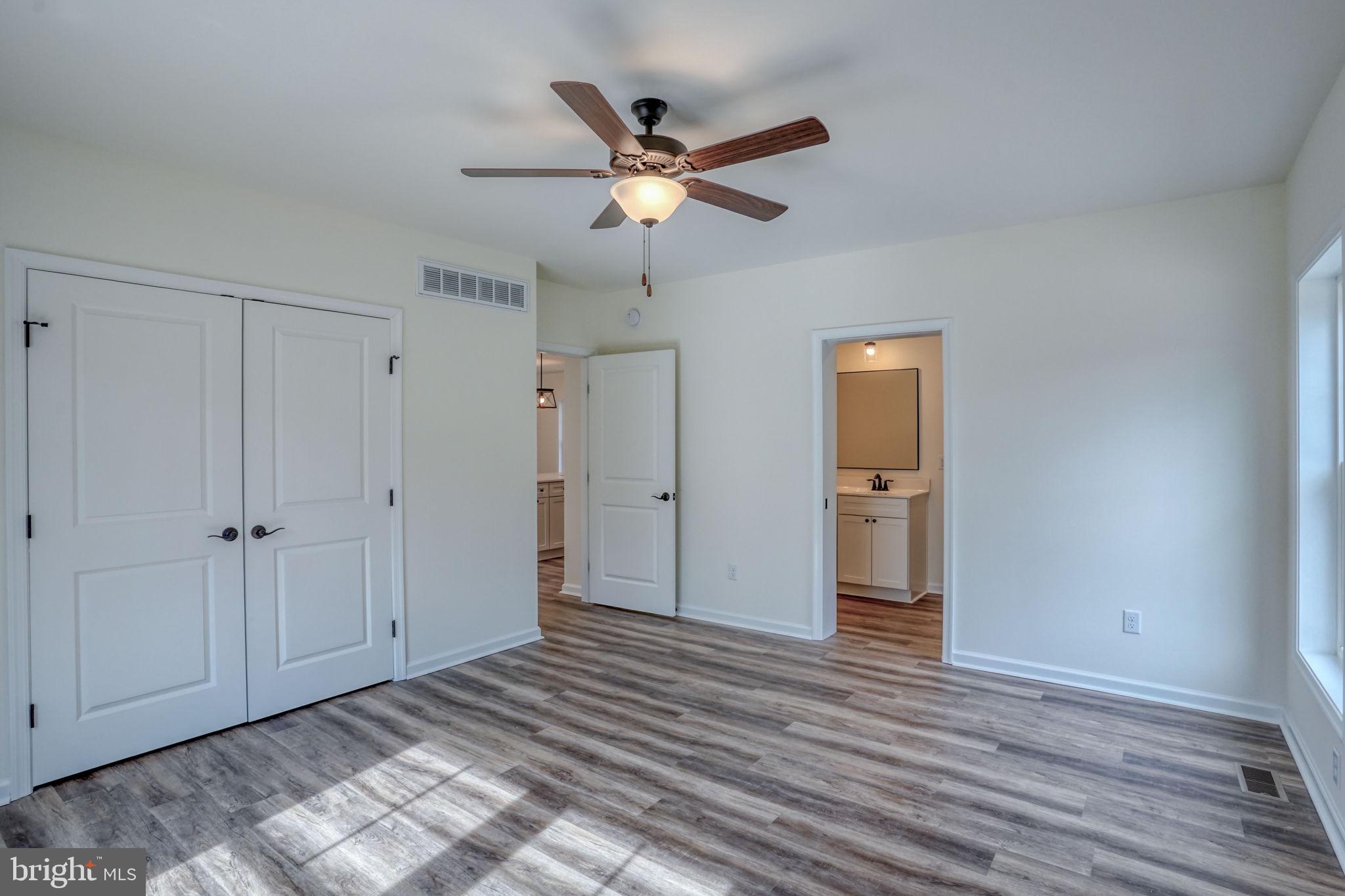 156 Pratts Branch Road Felton, DE 19943 - Photo 18 of 35 a view of a livingroom with a ceiling fan & wooden floor