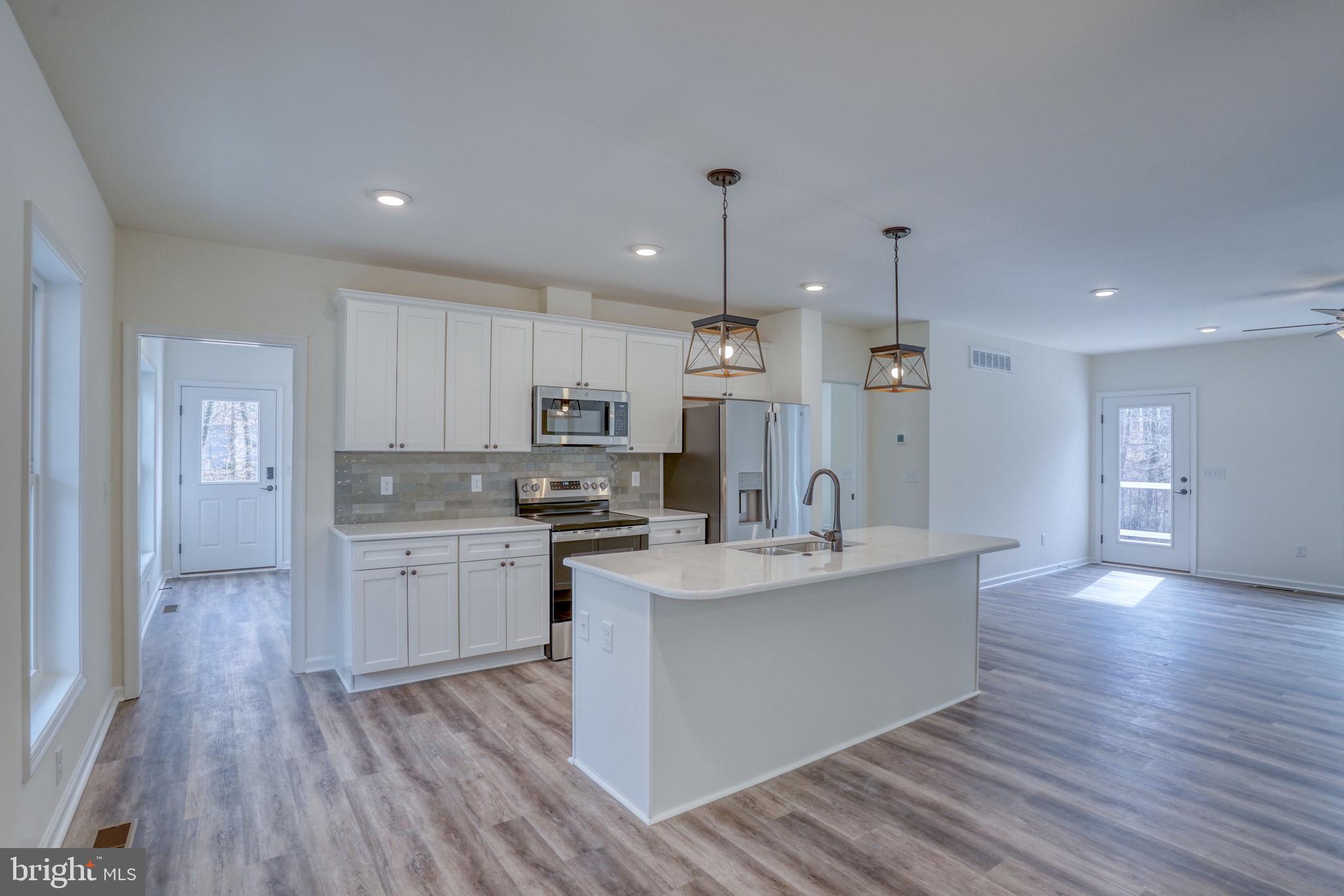156 Pratts Branch Road Felton, DE 19943 - Photo 10 of 35 a large kitchen with stainless steel appliances kitchen island a large counter top and sink