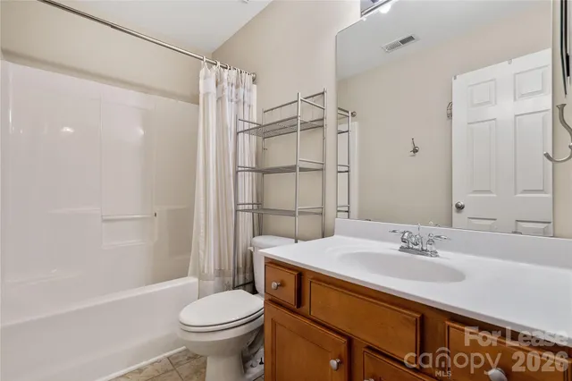 an empty room with wooden floor a fireplace and a window