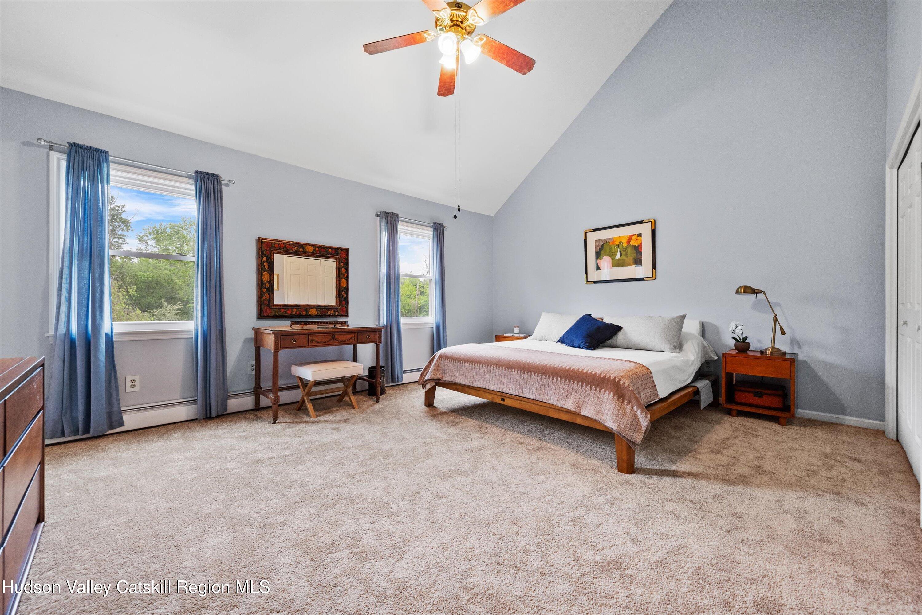 141 East Ridge Road Warwick, NY 10990 - Photo 28 of 57 a bedroom with a bed and a chandelier