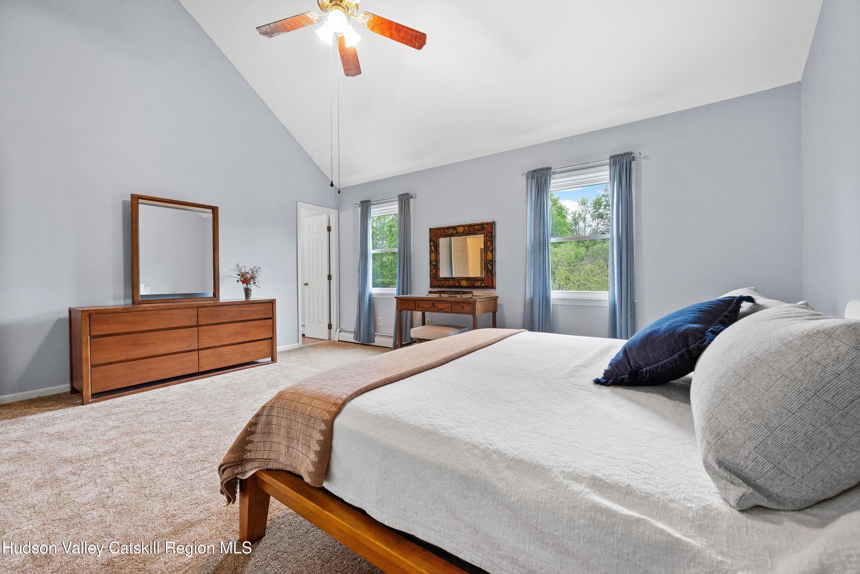 141 East Ridge Road Warwick, NY 10990 - Photo 29 of 57 a bedroom with a bed and a chandelier