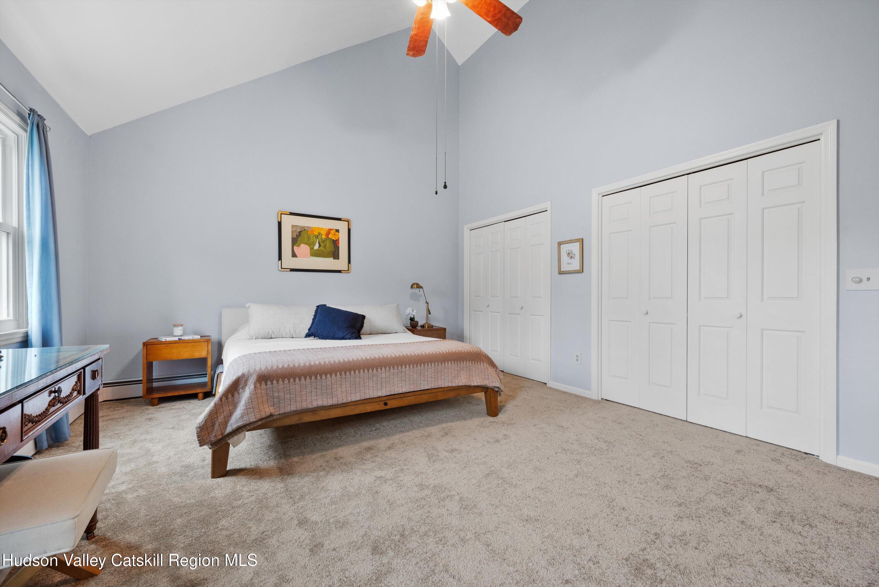 141 East Ridge Road Warwick, NY 10990 - Photo 31 of 57 a spacious bedroom with a bed and a chandelier