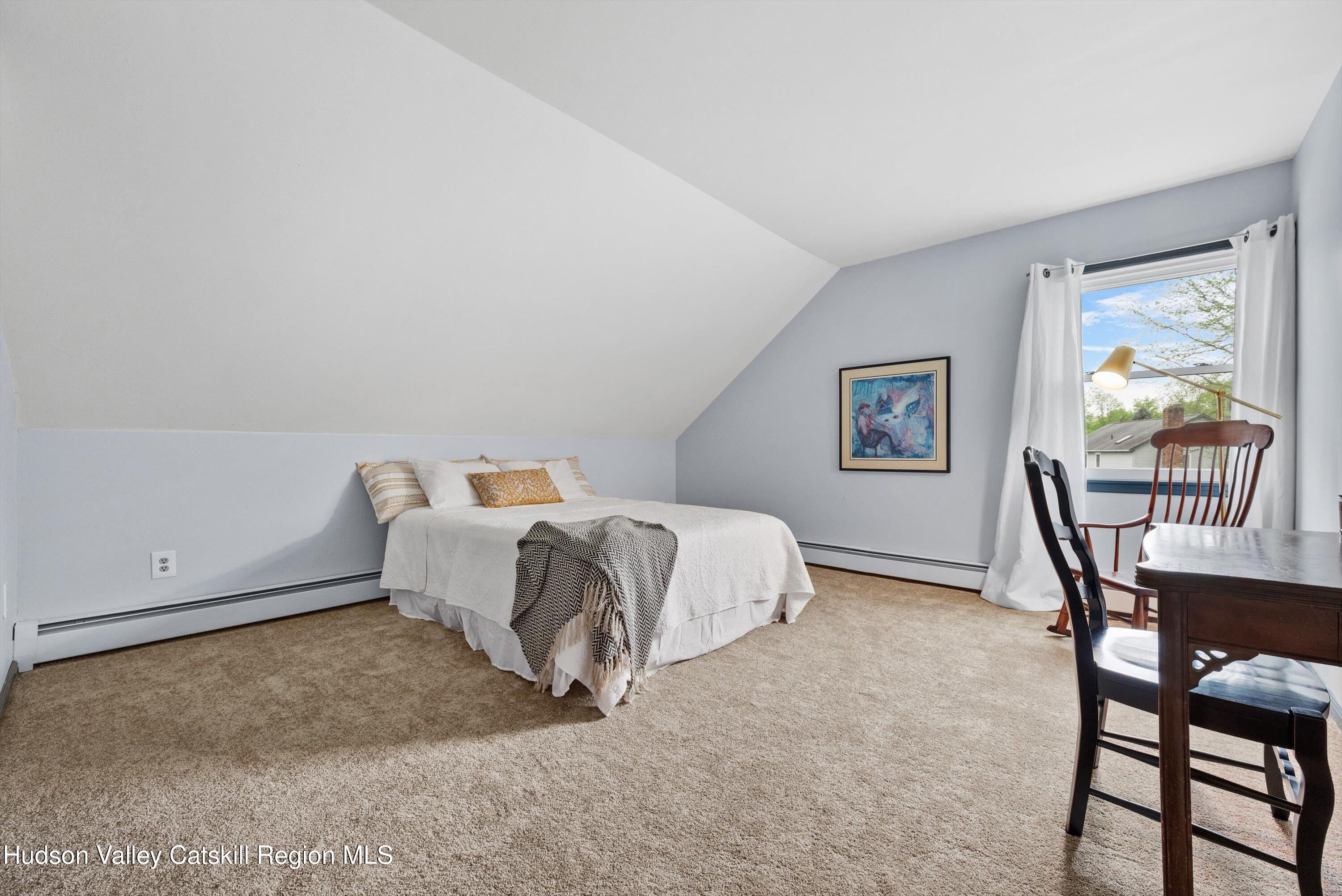 141 East Ridge Road Warwick, NY 10990 - Photo 35 of 57 a bedroom with a bed a table and chair