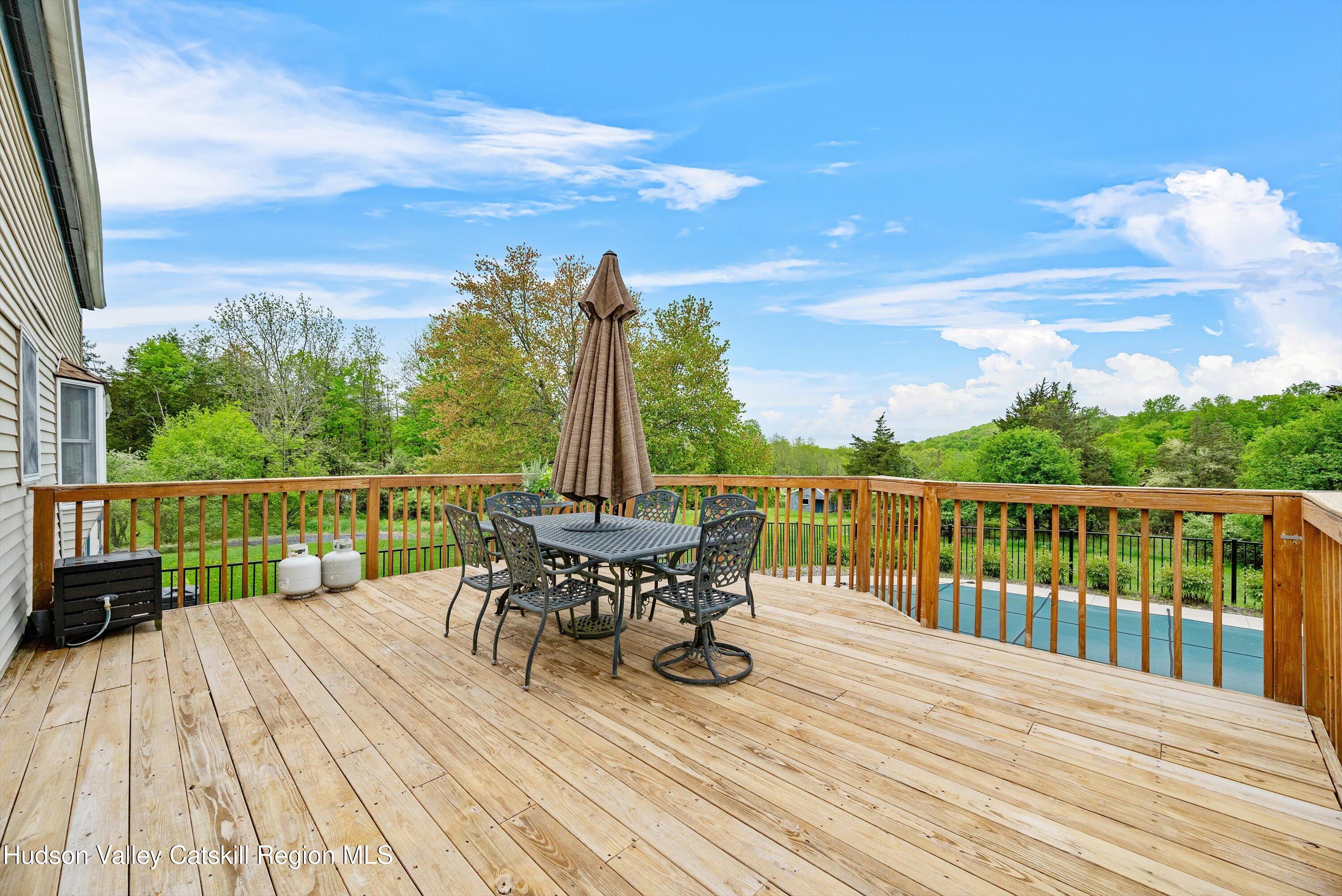 141 East Ridge Road Warwick, NY 10990 - Photo 41 of 57 a view of a deck with two chair and wooden floor