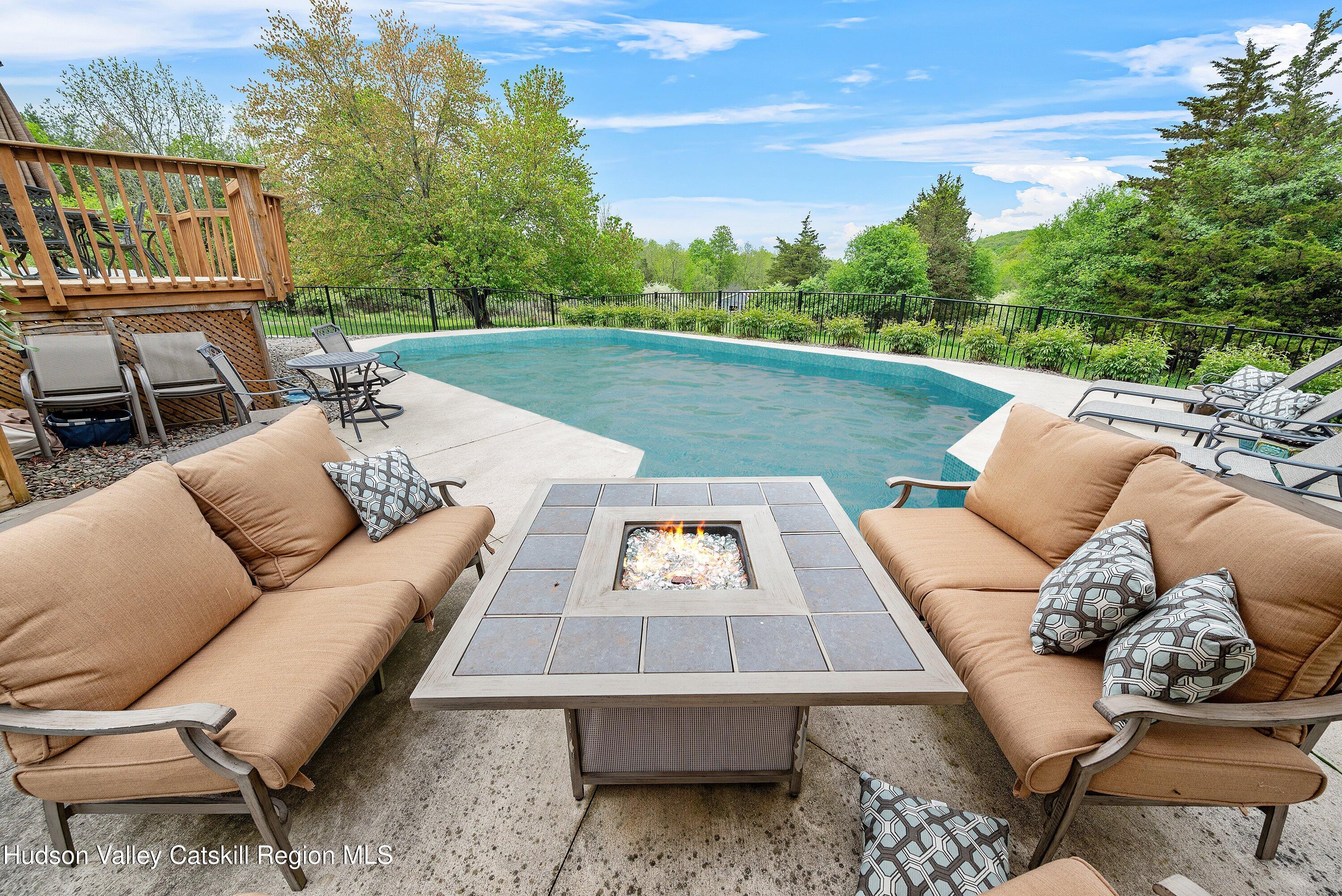 141 East Ridge Road Warwick, NY 10990 - Photo 44 of 57 a view of a patio with couches table and chairs with wooden floor and fence