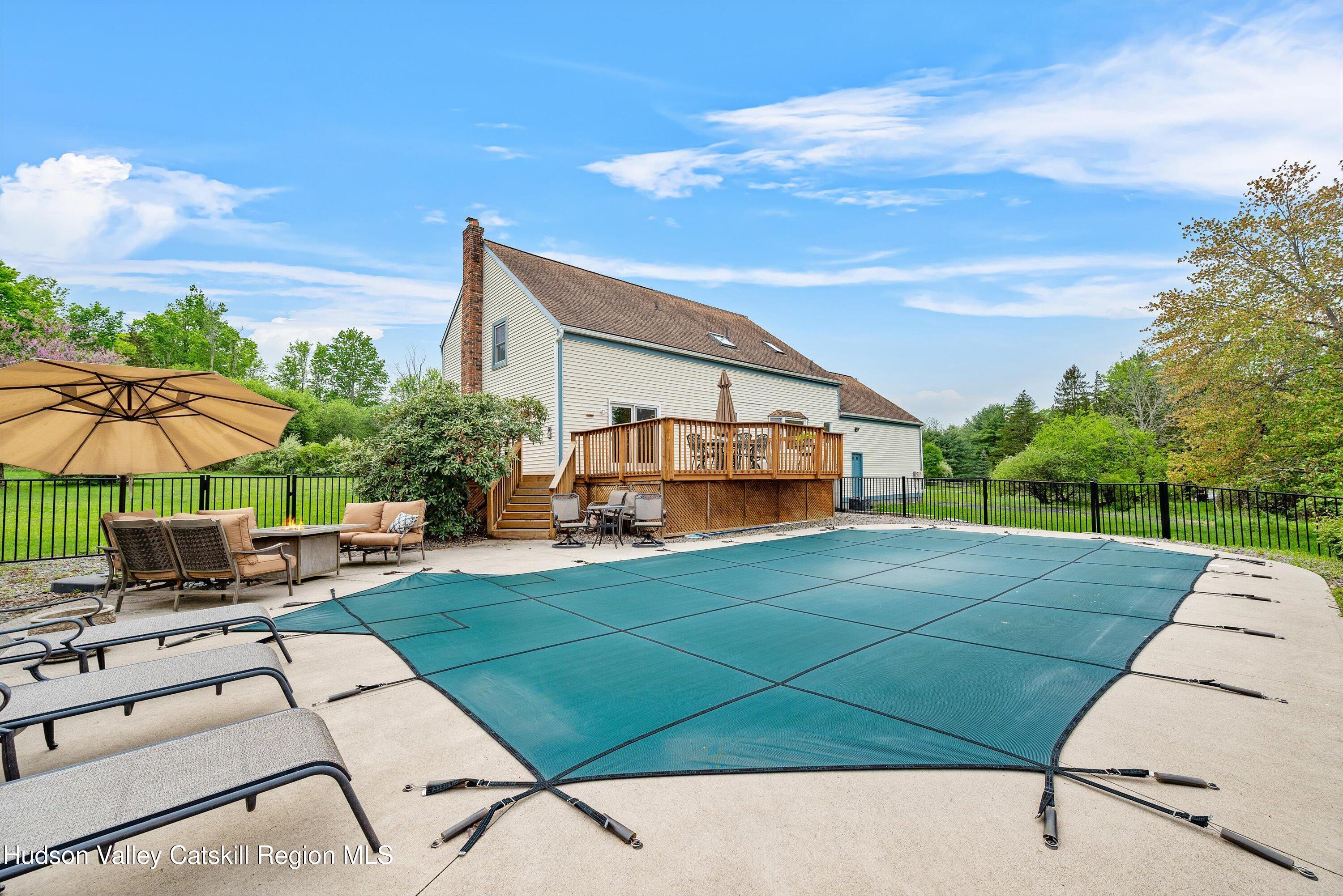 141 East Ridge Road Warwick, NY 10990 - Photo 45 of 57 a view of a patio with couches table and chairs under an umbrella