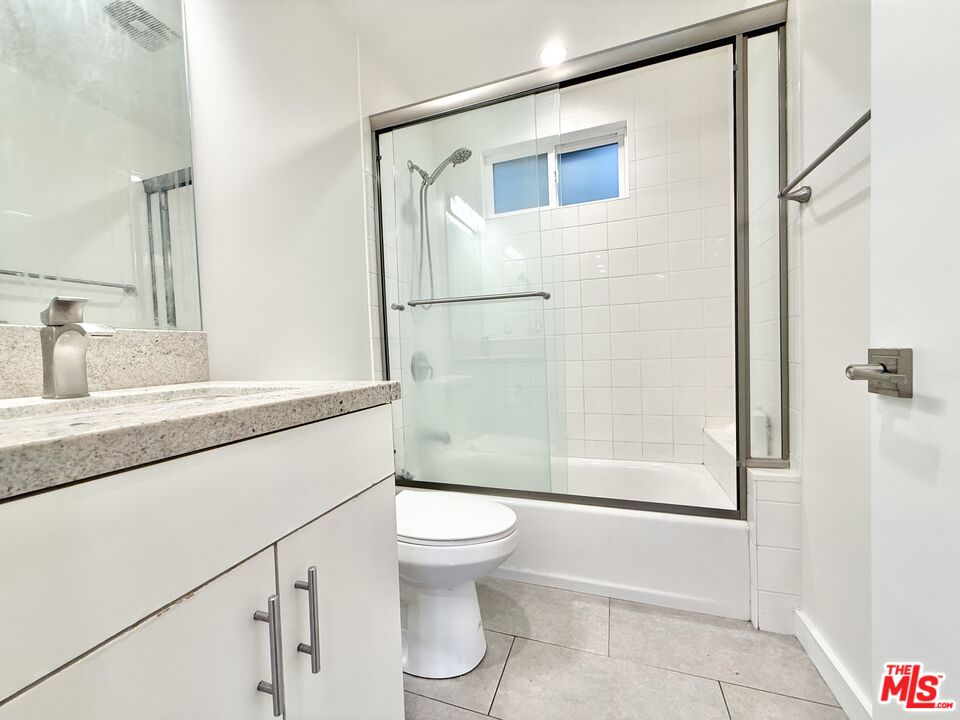3245 Drew Street Los Angeles, CA 90065 - Photo 3 of 7 a bathroom with a granite countertop sink toilet and shower