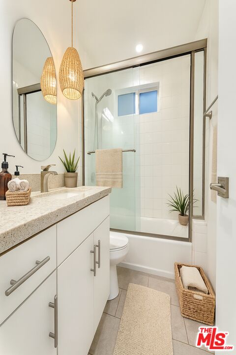 3245 Drew Street Los Angeles, CA 90065 - Photo 6 of 7 a bathroom with a granite countertop sink mirror vanity and toilet