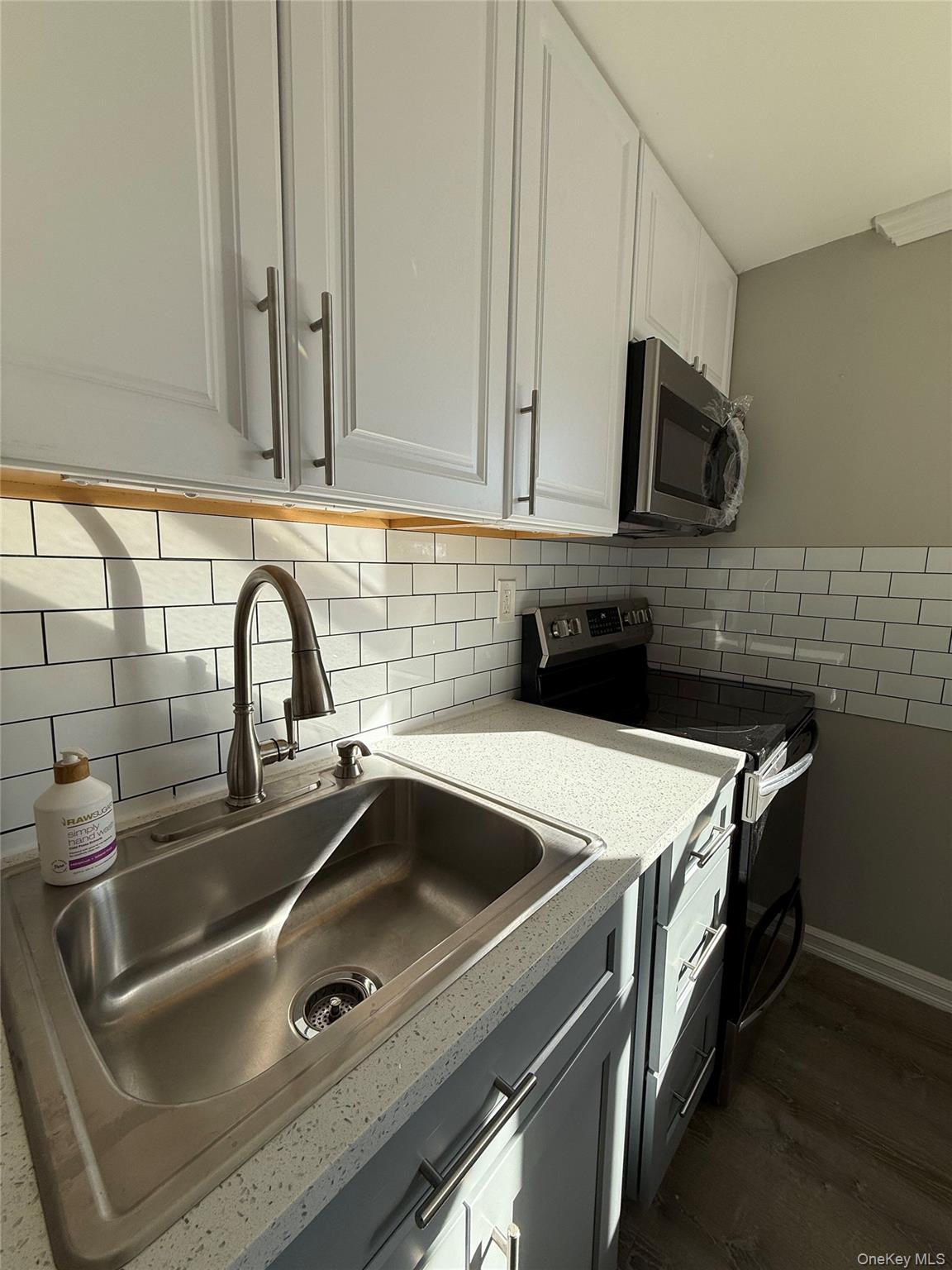 44 Pine Street Blue Point, NY 11715 - Photo 7 of 17 a close view of a sink and dishwasher with kitchen island