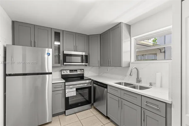 a kitchen with a refrigerator sink and stove