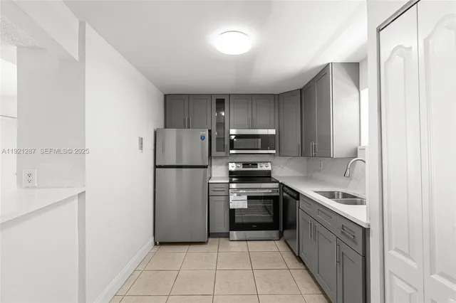 a kitchen with a sink stainless steel appliances and cabinets