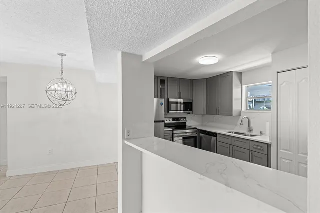 a kitchen with stainless steel appliances a sink stove and refrigerator
