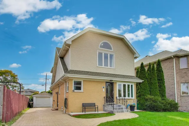 a front view of house with yard and green space