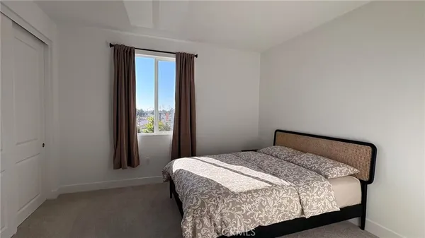 a bedroom with a bed and window