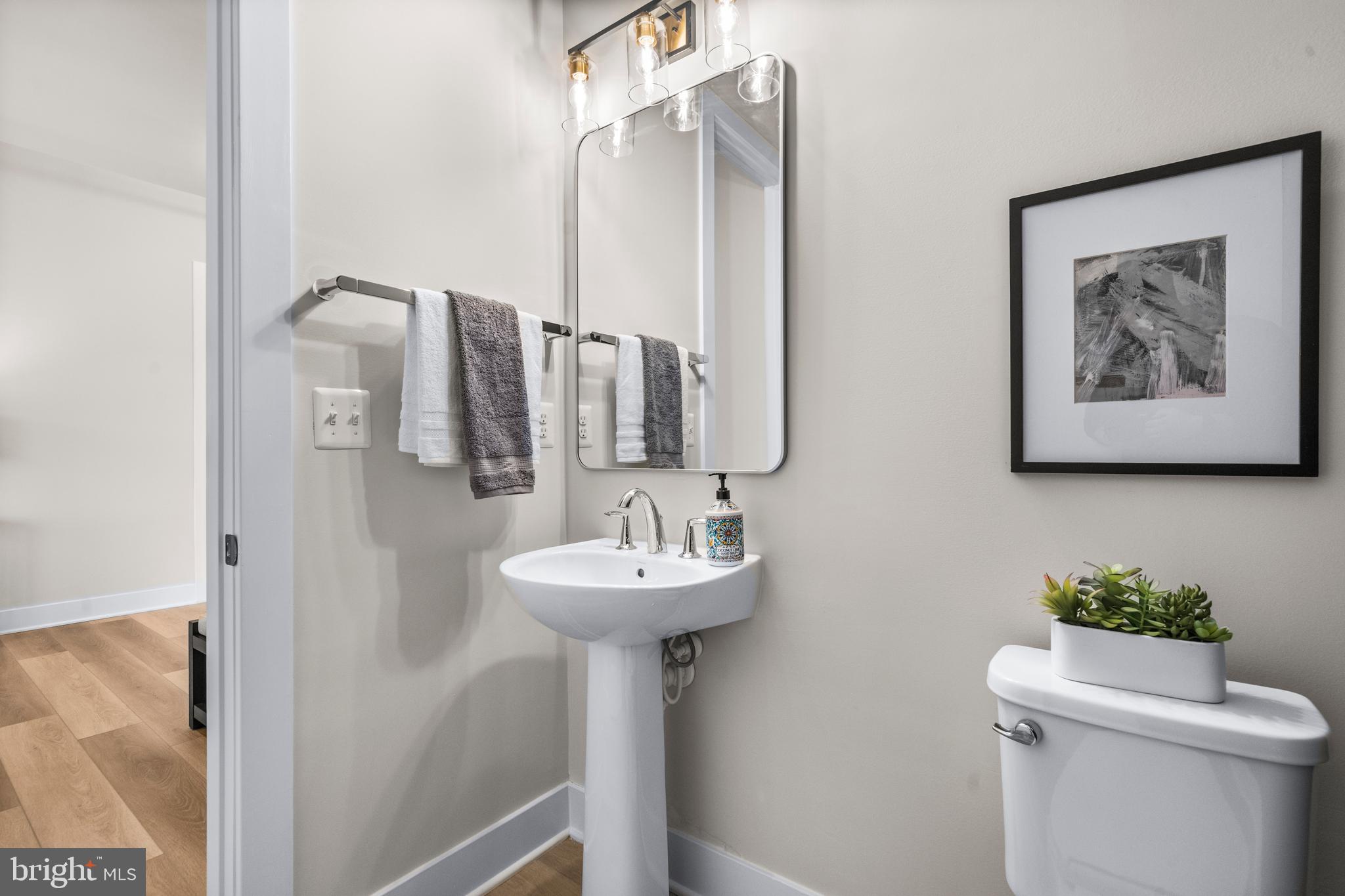 7505 Magarity Road Falls Church, VA 22043 - Photo 23 of 69 a bathroom with a sink mirror and toilet