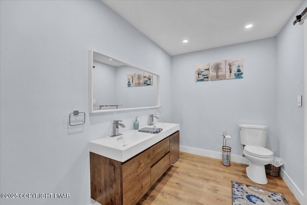 3118 Cherry Ridge Road Bushkill, PA 18324 - Photo 16 of 51 a bathroom with a sink mirror vanity and toilet