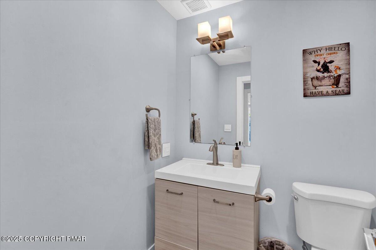 3118 Cherry Ridge Road Bushkill, PA 18324 - Photo 18 of 51 a bathroom with a toilet a sink and mirror