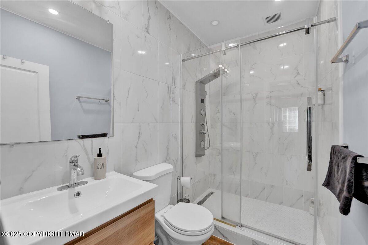 3118 Cherry Ridge Road Bushkill, PA 18324 - Photo 19 of 51 a bathroom with a sink toilet and shower