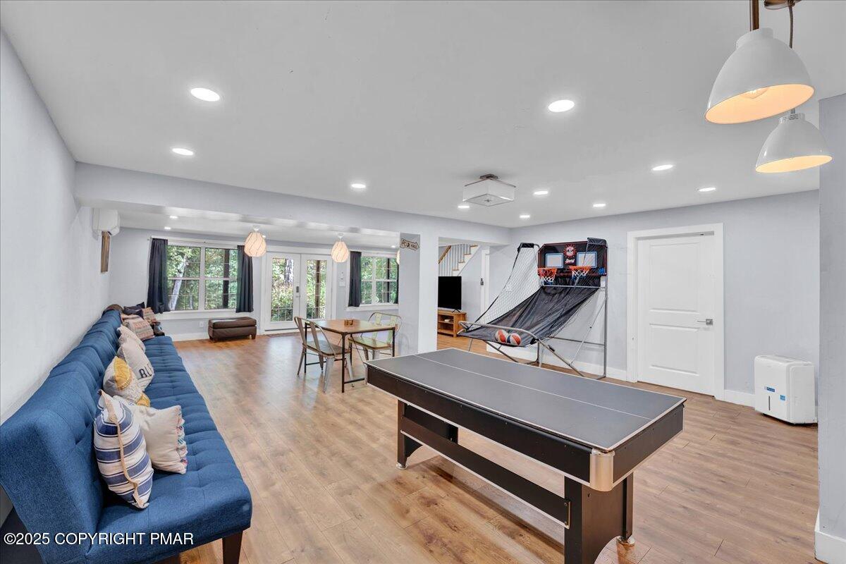 3118 Cherry Ridge Road Bushkill, PA 18324 - Photo 25 of 51 a living room with furniture pool table wooden floor and a large window