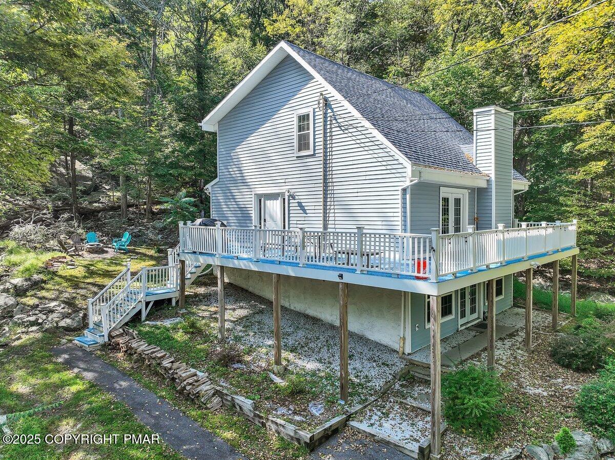 3118 Cherry Ridge Road Bushkill, PA 18324 - Photo 35 of 51 a backyard of a house with wooden deck patio and outdoor seating