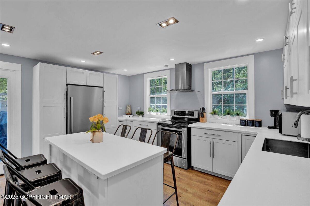 3118 Cherry Ridge Road Bushkill, PA 18324 - Photo 4 of 51 a kitchen that has a sink a table and chairs in it