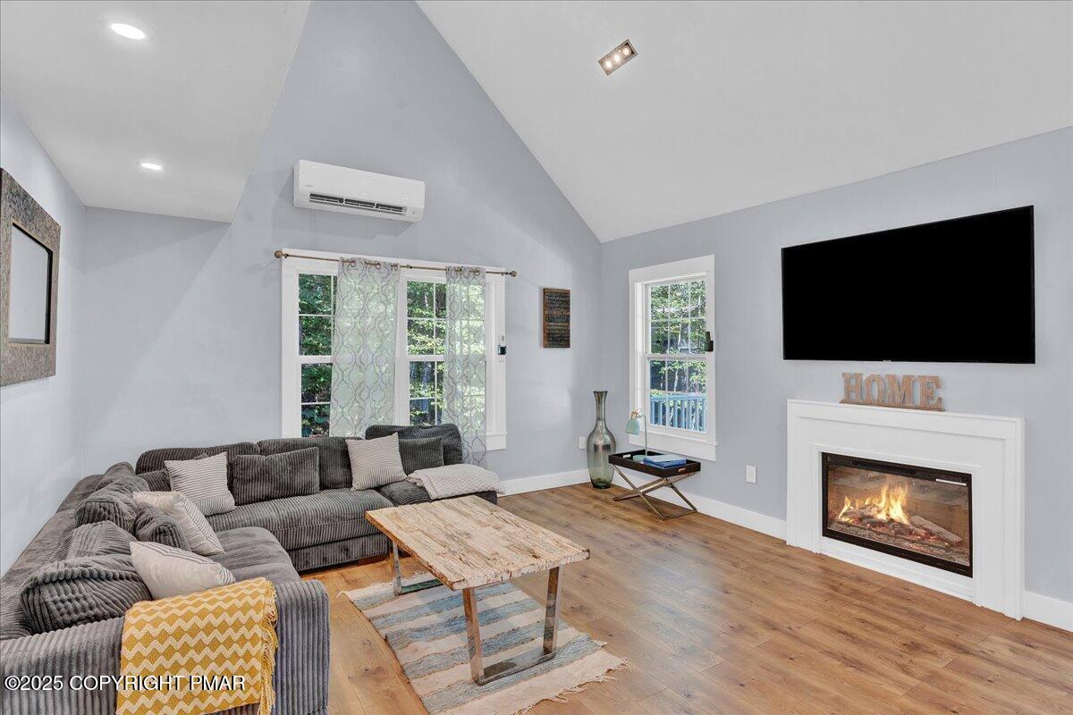 3118 Cherry Ridge Road Bushkill, PA 18324 - Photo 8 of 51 a living room with furniture a flat screen tv and a fireplace