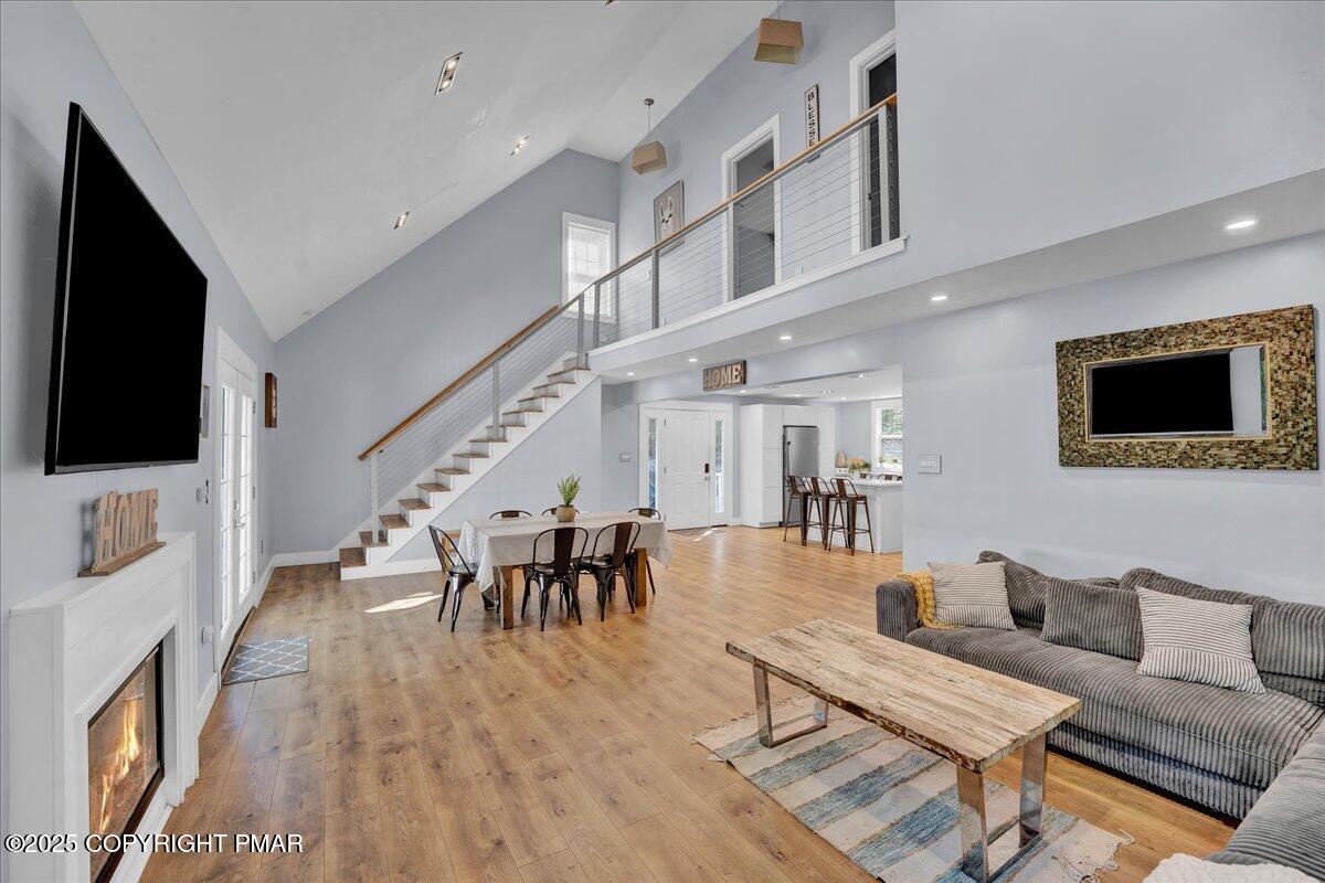 3118 Cherry Ridge Road Bushkill, PA 18324 - Photo 9 of 51 a living room with furniture a flat screen tv and a fireplace