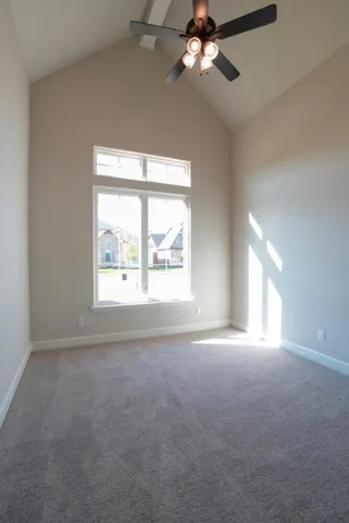 an empty room with a window and a fan
