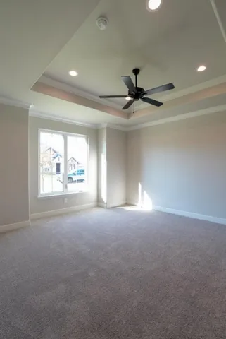 a view of a livingroom with a ceiling fan and window
