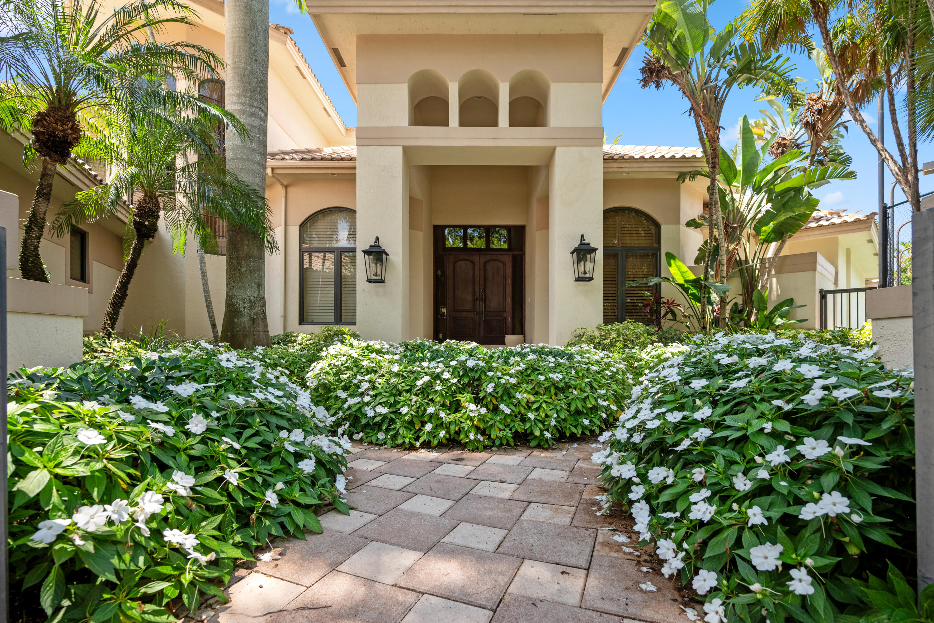 18800 Long Lake Drive Boca Raton, FL 33496 - Photo 4 of 60 a front view of a house with a garden