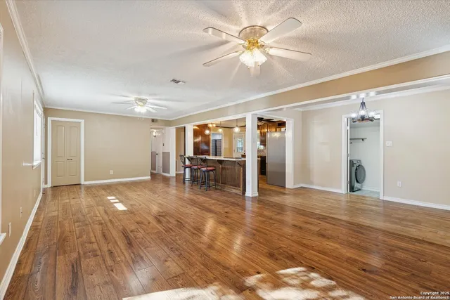 a view of empty room with wooden floor