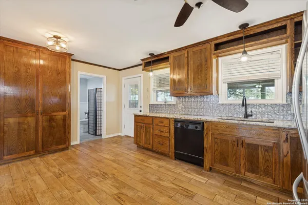 a spacious bathroom with a shower a sink and a large mirror