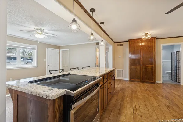 a kitchen with stainless steel appliances granite countertop a sink a stove and a refrigerator