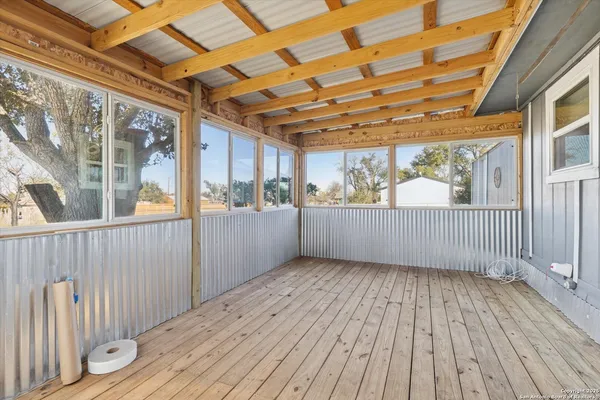 a view of a porch with wooden floor and outdoor space