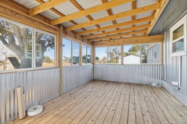 a view of a porch with wooden floor and outdoor space