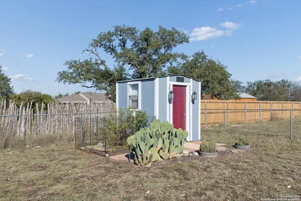 a view of a chair and table in the backyard