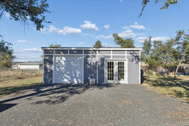 a view of a house with wooden fence