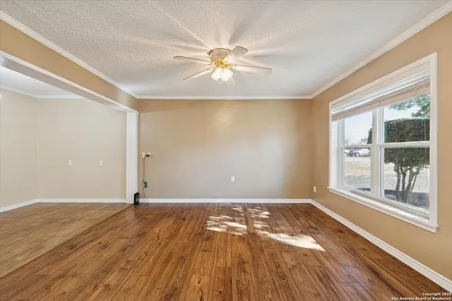 wooden floor in an empty room with a window