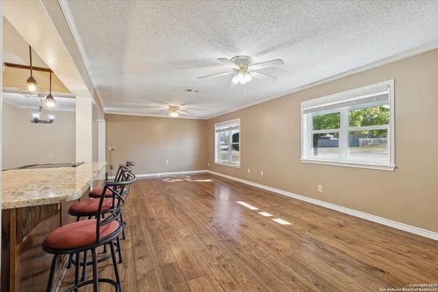a view of room with workspace and wooden floor