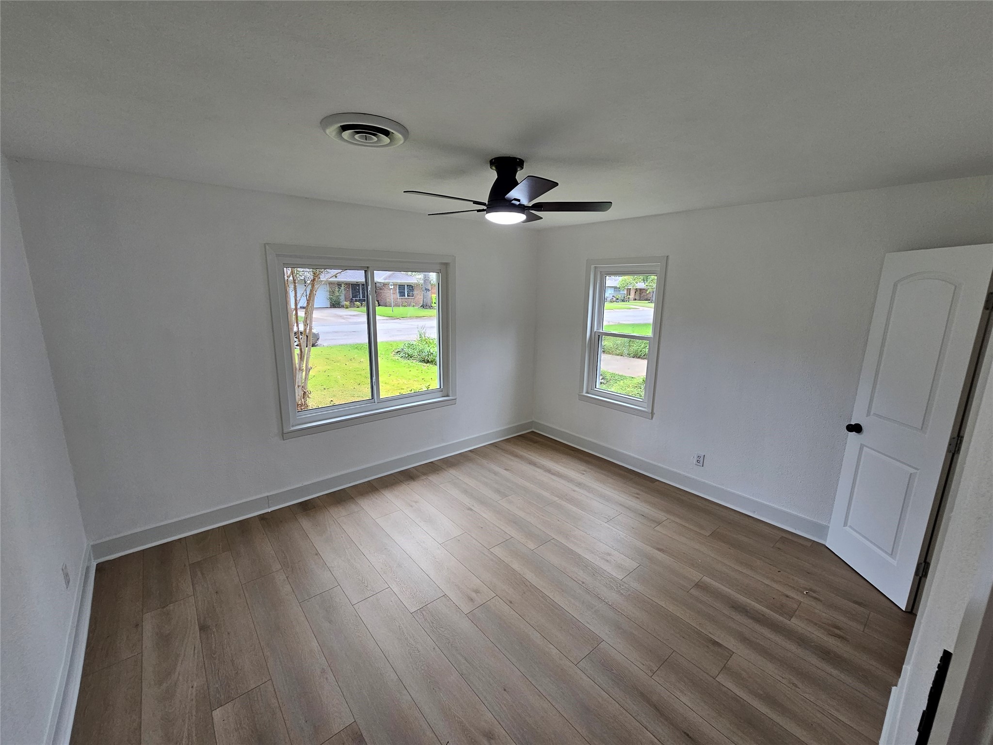 1300 Lawrence Street Rosenberg, TX 77471 - Photo 16 of 21 a view of an empty room with window and wooden floor