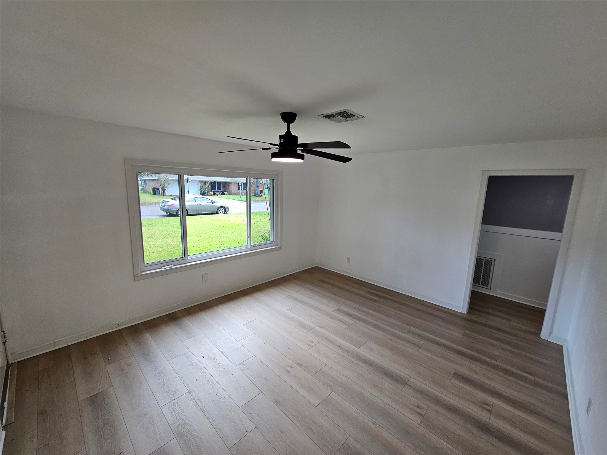1300 Lawrence Street Rosenberg, TX 77471 - Photo 17 of 21 wooden floor in an empty room with a window