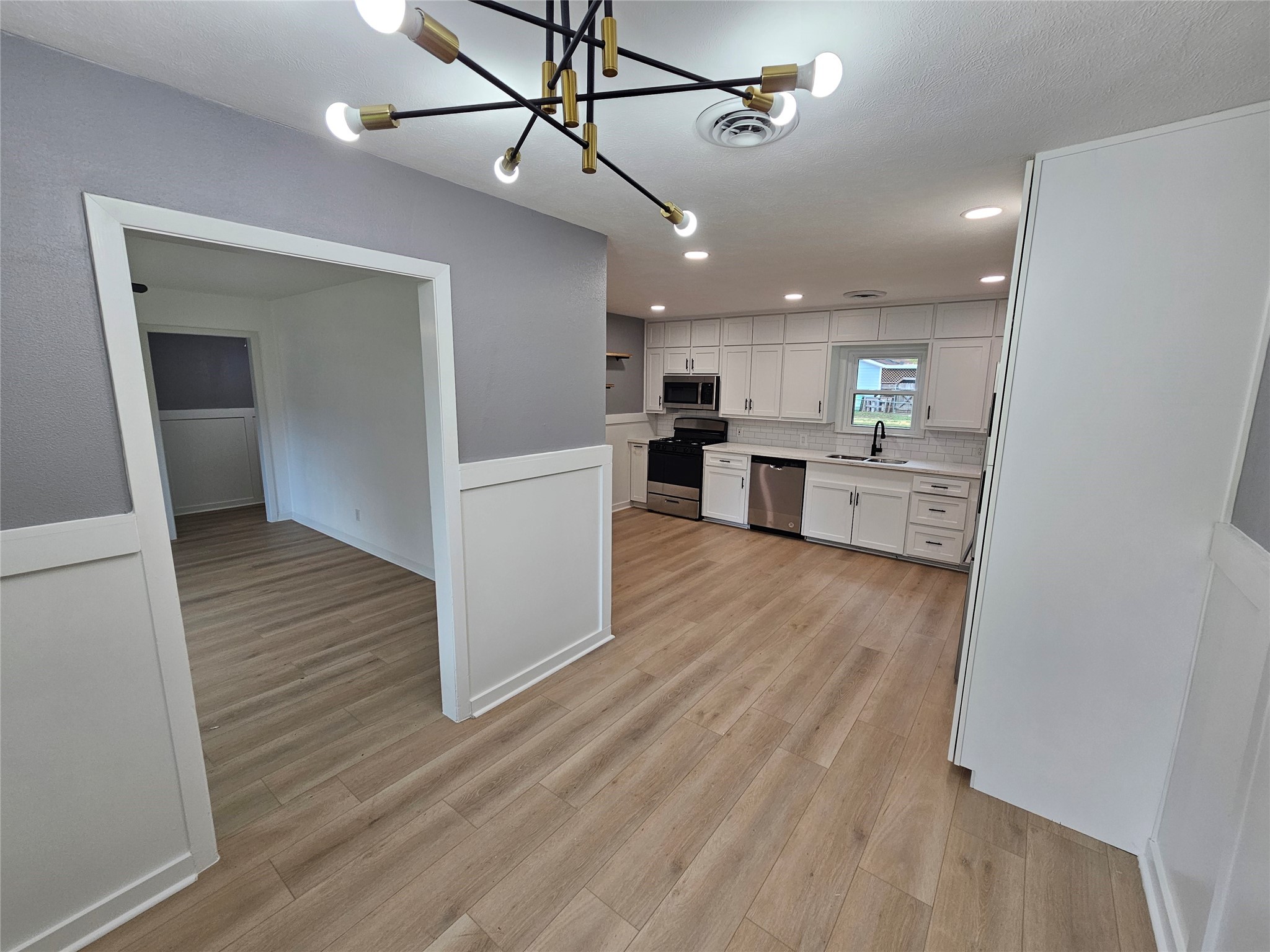 1300 Lawrence Street Rosenberg, TX 77471 - Photo 6 of 21 a view of a kitchen and kitchen with a wooden floor