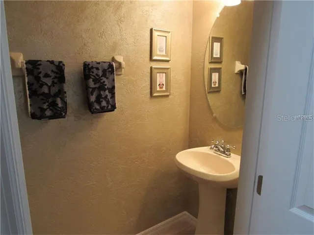 a bathroom with a sink and mirror