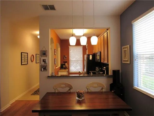 a room with pool table and windows