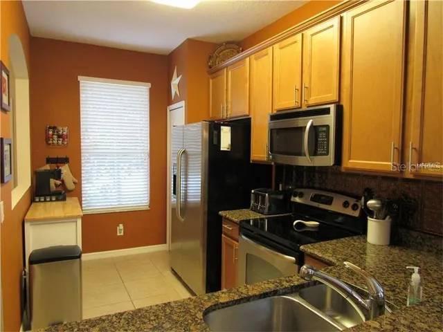 a kitchen with a sink appliances and cabinets