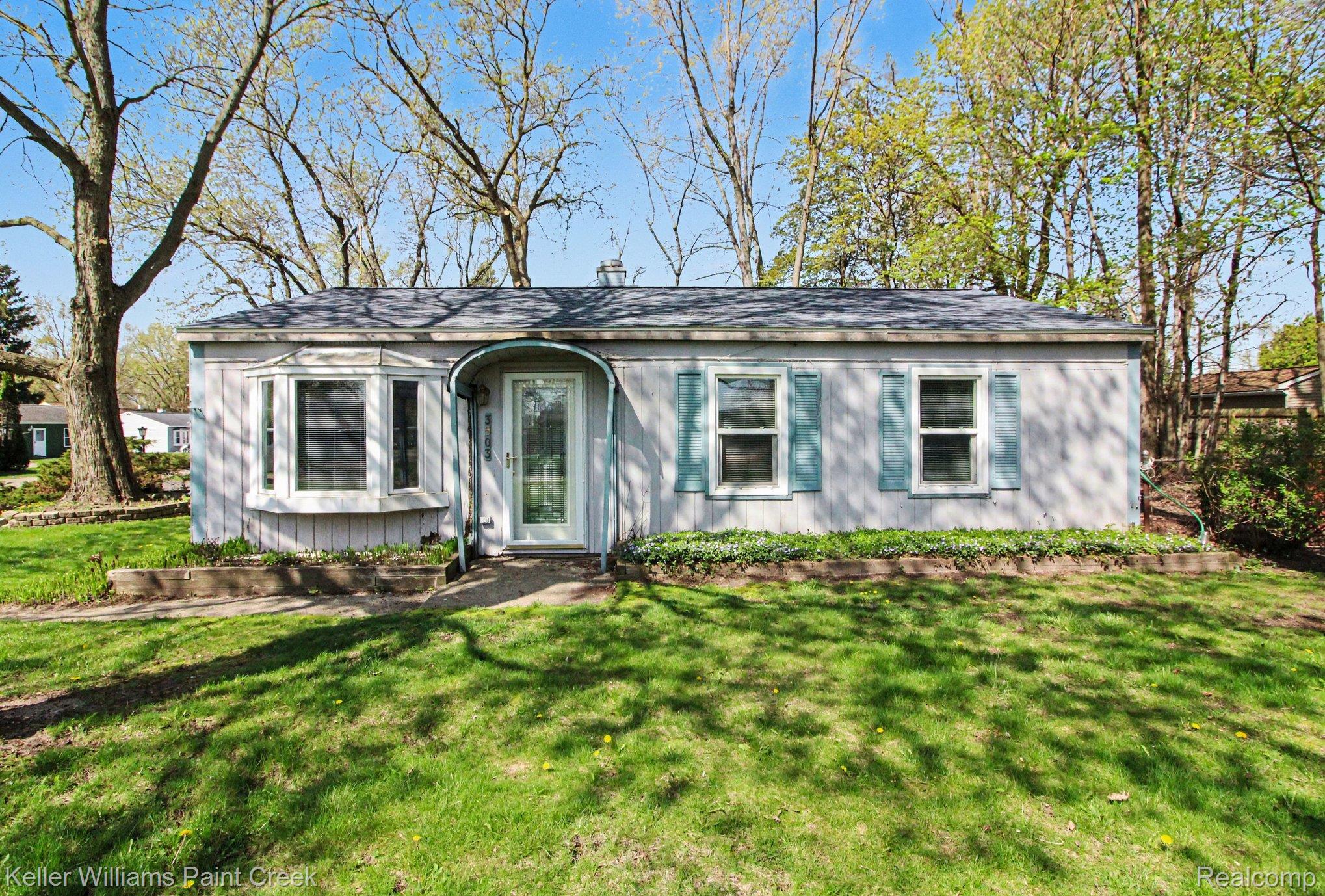 3503 Minton Road Lake Orion, MI 48359 - Photo 1 of 18 Set on a large corner lot surrounded by tall, mature trees!